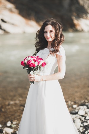 Portrait of stunning bride with long hair posing with great bouquetの写真素材