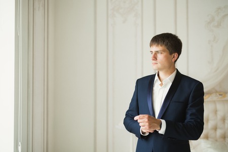 Portrait of happy businessman standing in studioの写真素材