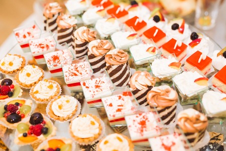 Delicious and tasty dessert table with cupcakes shots at reception closeupの写真素材