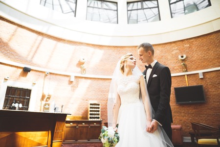 Perfect couple bride, groom posing and kissing in their wedding dayの写真素材