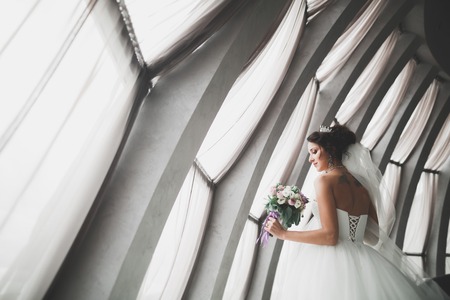 Portrait of stunning bride with long hair posing with great bouquetの写真素材