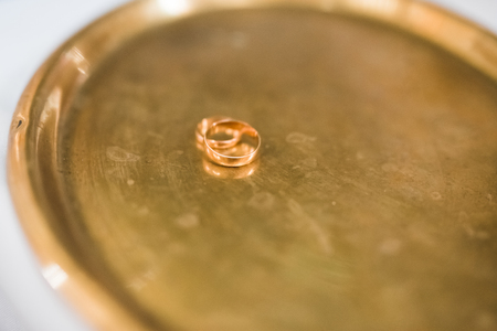Two golden wedding rings isolated background conceptの写真素材