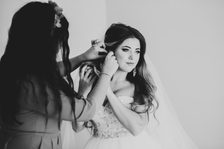 Luxury bride in white dress posing while preparing for the wedding ceremonyの写真素材