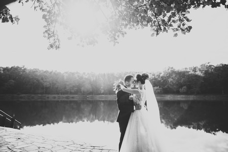 Kissing wedding couple in spring nature close-up portraitの写真素材