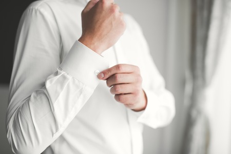 Beautiful man, groom posing and preparing for wedding