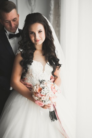 Perfect couple bride, groom posing and kissing in their wedding day