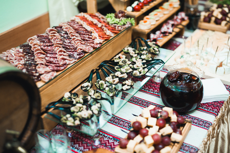 Delicious sweets on wedding candy buffet with desserts, cupcakes.の写真素材