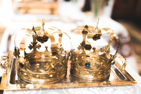 Golden crowns lying on the table in churchの写真素材