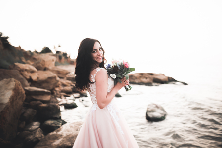 Portrait of stunning bride with long hair posing with great bouquetの写真素材