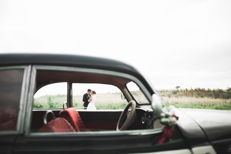 Just married couple in the luxury retro car on their wedding day.の写真素材