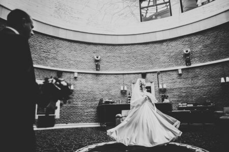 Beautiful bride spinning with perfect dress in a restaurant.の写真素材