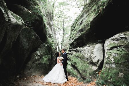 Gorgeous happy couple standing close to each other and looking in eyesの写真素材