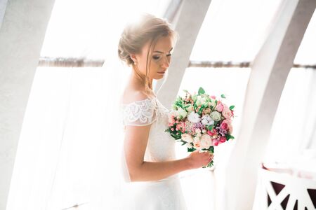 Portrait of a beautiful fashion bride, sweet and sensual. Wedding make up and hairの写真素材