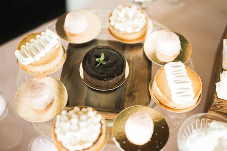Delicious and tasty dessert table with cupcakes and shots at reception closeup.の写真素材
