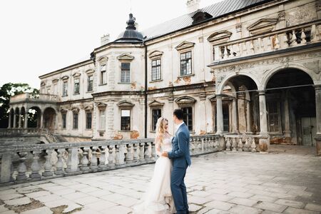 Romantic wedding moment, couple of newlyweds smiling portrait, bride and groom hugging.の写真素材
