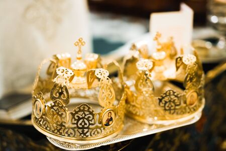 Golden crowns lying on the table in church.の写真素材