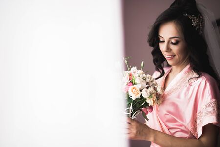 Bride holding big and beautiful wedding bouquet with flowersの写真素材