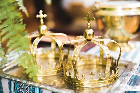 Golden crowns lying on the table in church.の写真素材