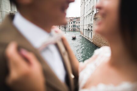 Gorgeous happy couple standing close to each other and looking in eyes.の写真素材