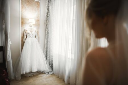Luxury bride in white dress posing while preparing for the wedding ceremonyの写真素材
