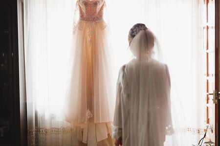 Luxury bride in white dress posing while preparing for the wedding ceremonyの写真素材