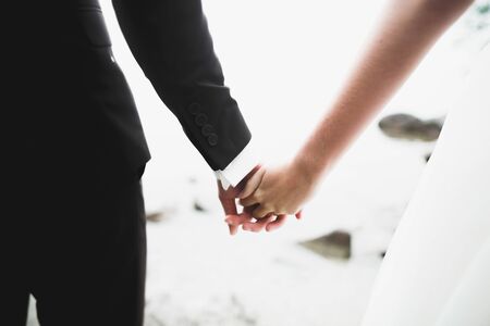 Wedding couple bride and groom holding handsの写真素材