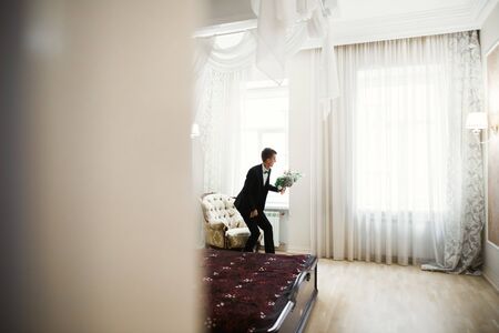 Beautiful man, groom posing and preparing for weddingの写真素材