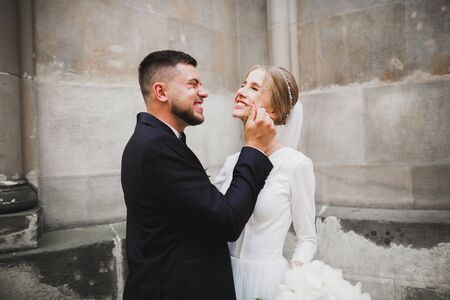 Romantic wedding moment, couple of newlyweds smiling portrait, bride and groom huggingの写真素材