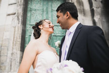Lovely wedding couple kissing in the old cityの写真素材