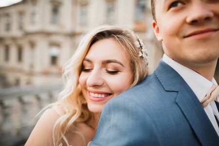 Romantic wedding moment, couple of newlyweds smiling portrait, bride and groom huggingの写真素材