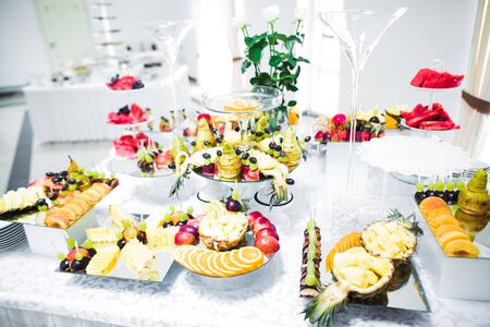 Delicious and tasty dessert table with cupcakes and shots at reception closeup.の写真素材