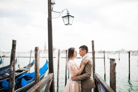 Gorgeous happy couple standing close to each other and looking in eyesの写真素材