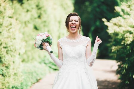 Luxury wedding bride, girl posing and smiling with bouquetの写真素材