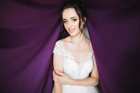 Beautiful bride wearing fashion wedding dress with feathers with luxury delight make-up and...
