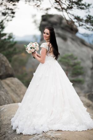 Bride holding big and beautiful wedding bouquet with flowersの写真素材