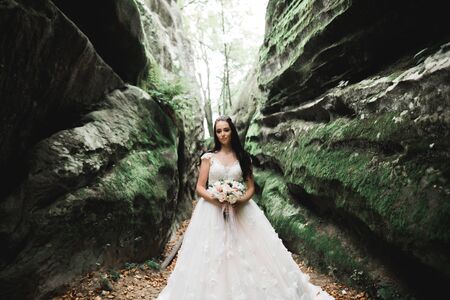 Portrait of stunning bride with long hair posing with great bouquetの写真素材