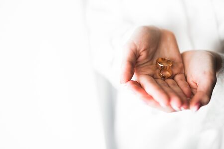 Newly wed couple's hands with wedding rings.の写真素材