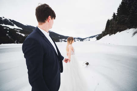 Woman with beautiful hair discovering beautiful places holding boyfriends hand. Follow meの写真素材