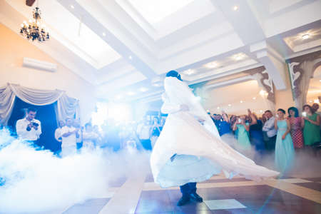First wedding dance of newlywed couple in restaurant