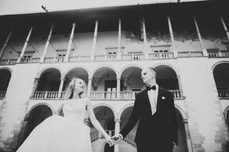 Lovely happy wedding couple, bride with long white dressの写真素材