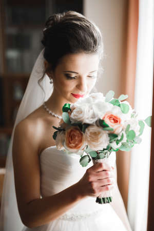 Beautiful fashion bride in wedding dress posingの写真素材