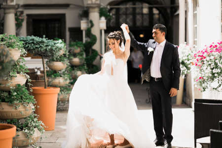 Beautiful bride spinning with perfect dress in the parkの写真素材