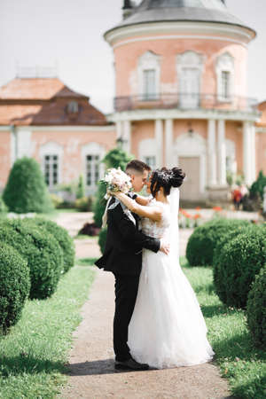 Gorgeous happy couple standing close to each other and looking in eyesの写真素材