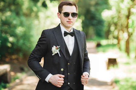 Headshot portrait of young man smiling isolated on outside outdoors backgroundの写真素材