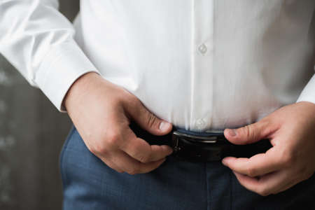 Beautiful man, groom posing and preparing for weddingの写真素材