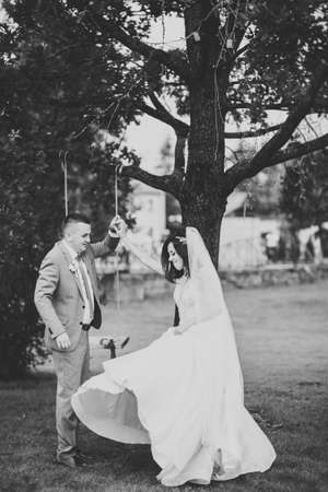Beautiful romantic wedding couple of newlyweds dancing in a parkの写真素材