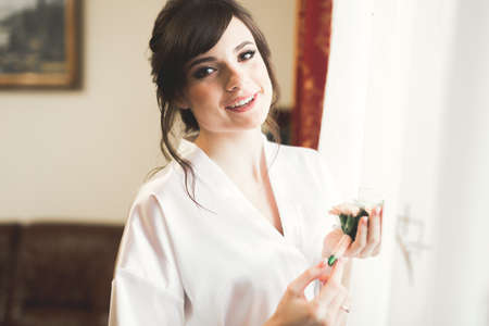 Portrait of beautiful bride with fashion veil at wedding morningの写真素材