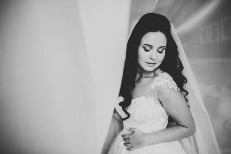 Portrait of stunning bride with long hair posing with great bouquet