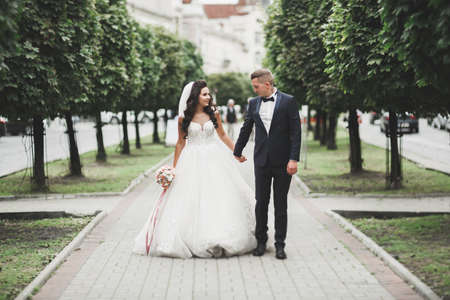 Lovely happy wedding couple, bride with long white dressの写真素材