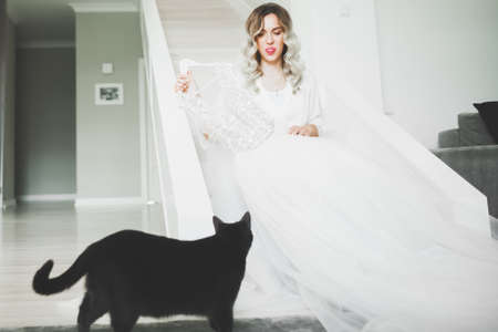 Luxury bride in white dress posing while preparing for the wedding ceremonyの写真素材